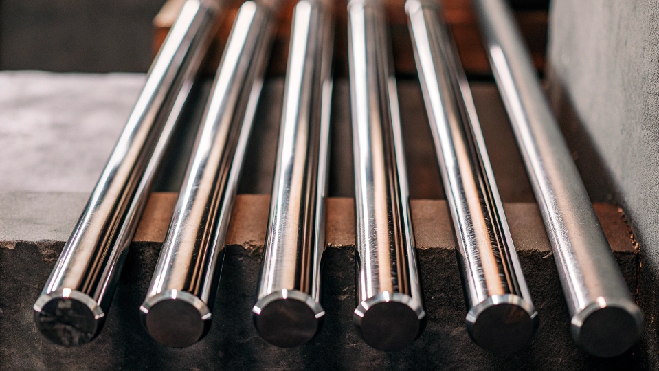 A collection of polished titanium rods of various sizes