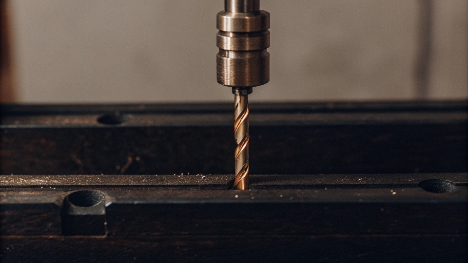 A gold-colored TiN coated drill bit, highlighting its hardness and durability