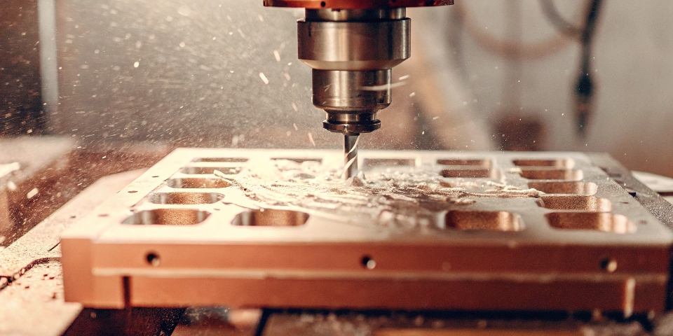 A block of aluminum being milled into a MacBook unibody