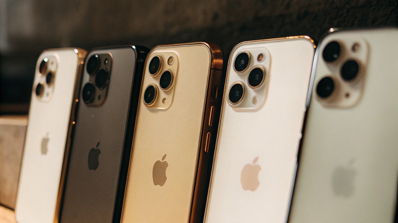 A lineup of the iPhone 15 models, with the Pro and Pro Max models highlighted to show their distinct look.